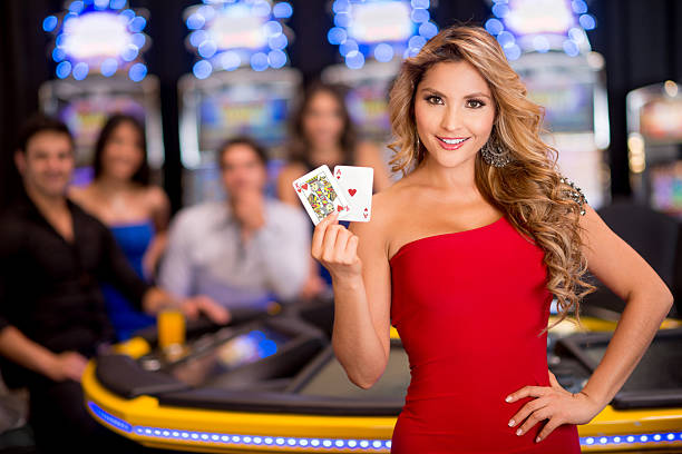 Happy woman at the casino playing cards (Note: Card design is our own)